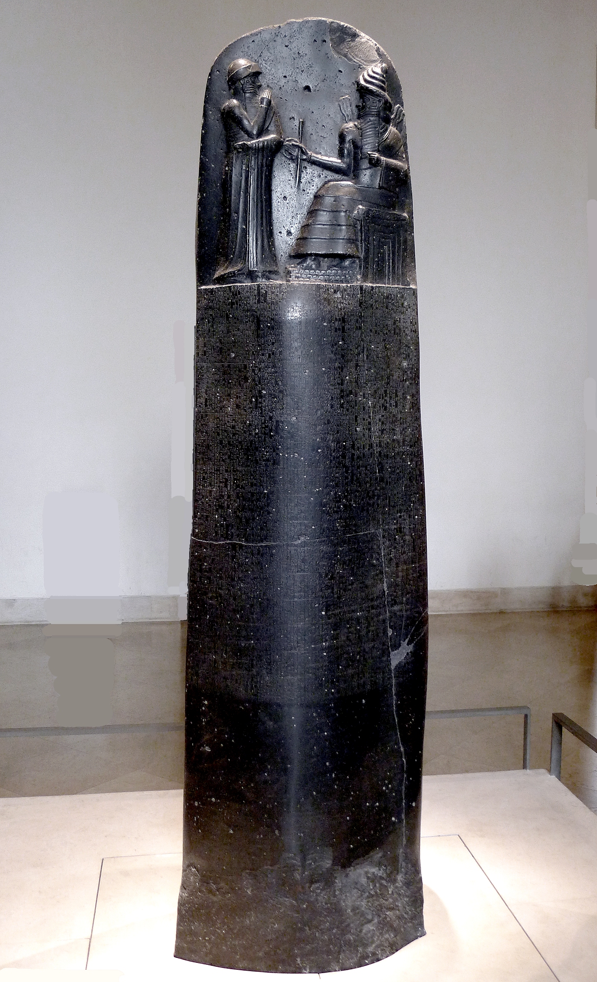 The Code of Hammurabi stela, a tall black basalt pillar with cuneiform and a relief at the top