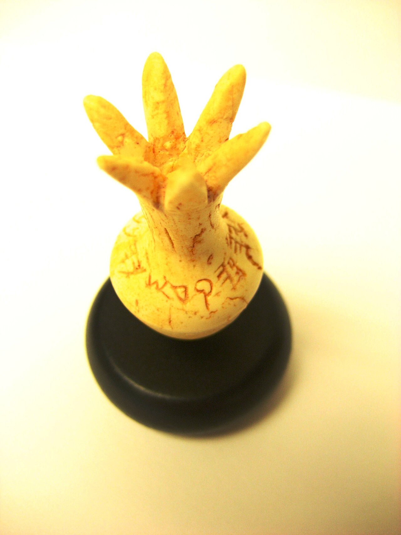 The small ivory pomegranate with a paleo-Hebrew inscription around its neck
