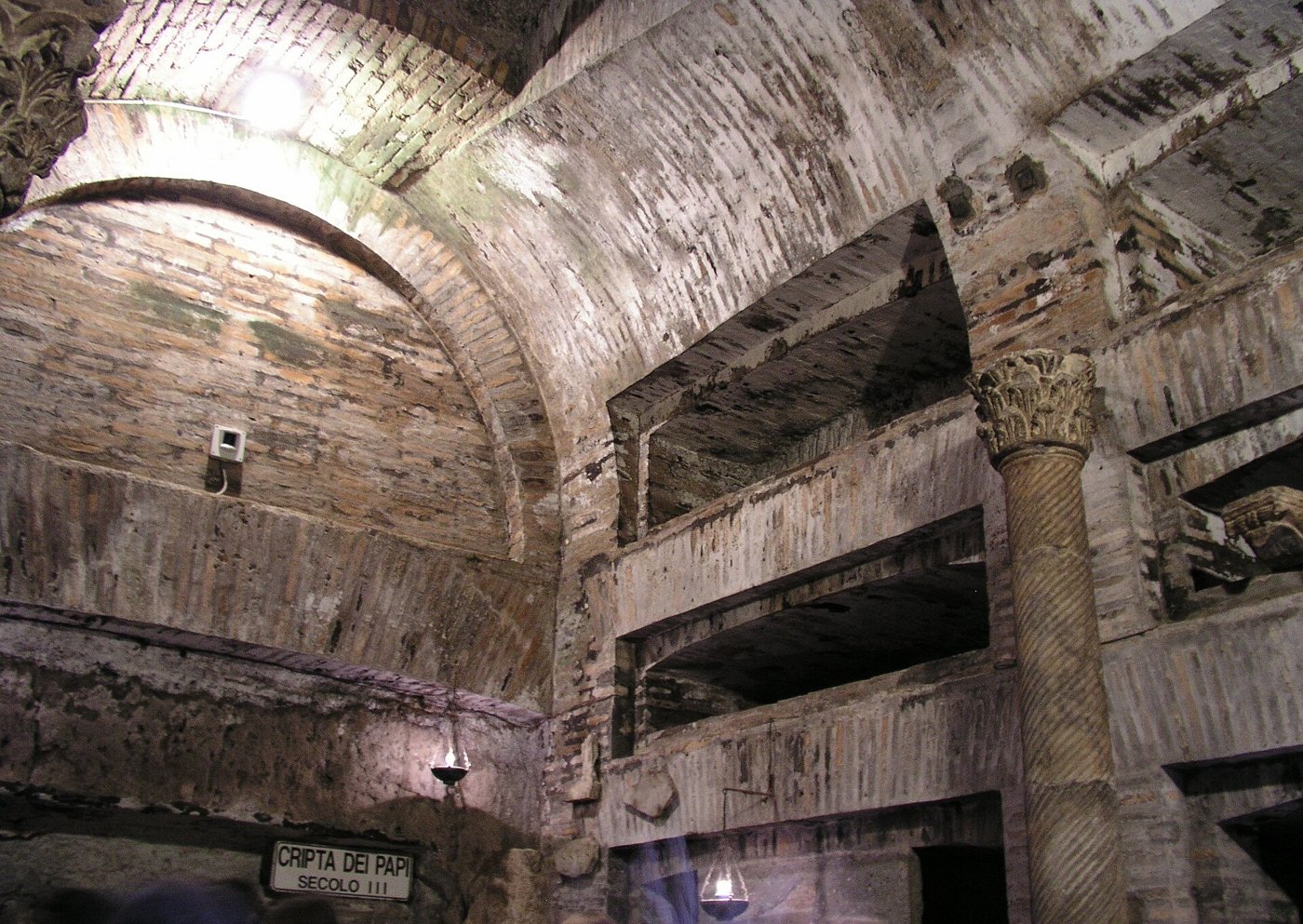 The third-century Crypt of the Popes in the Catacomb of Callixtus, with brick vaulting, burial niches and a twisted column