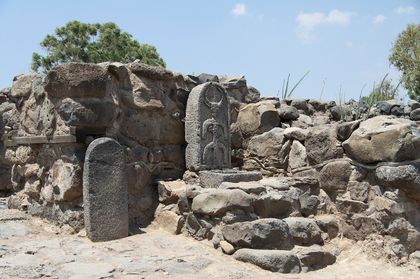 Basalt city gate at et-Tell with a carved stele and standing stone, a site often identified with Bethsaida