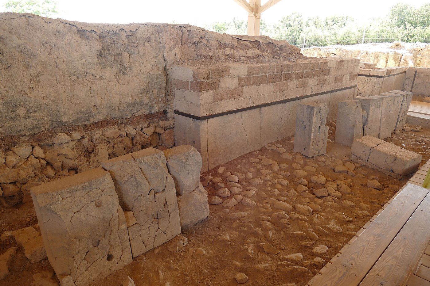 Excavated stone and mudbrick walls under a protective shelter at Tel Hazor
